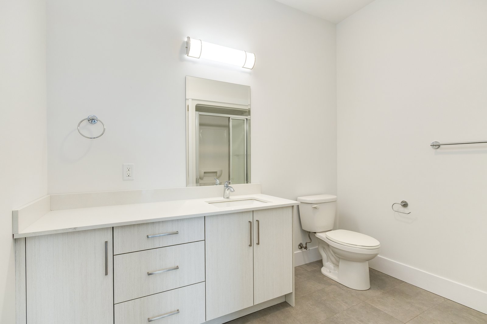 Bathroom with a vanity, mirror, and glass shower stall
